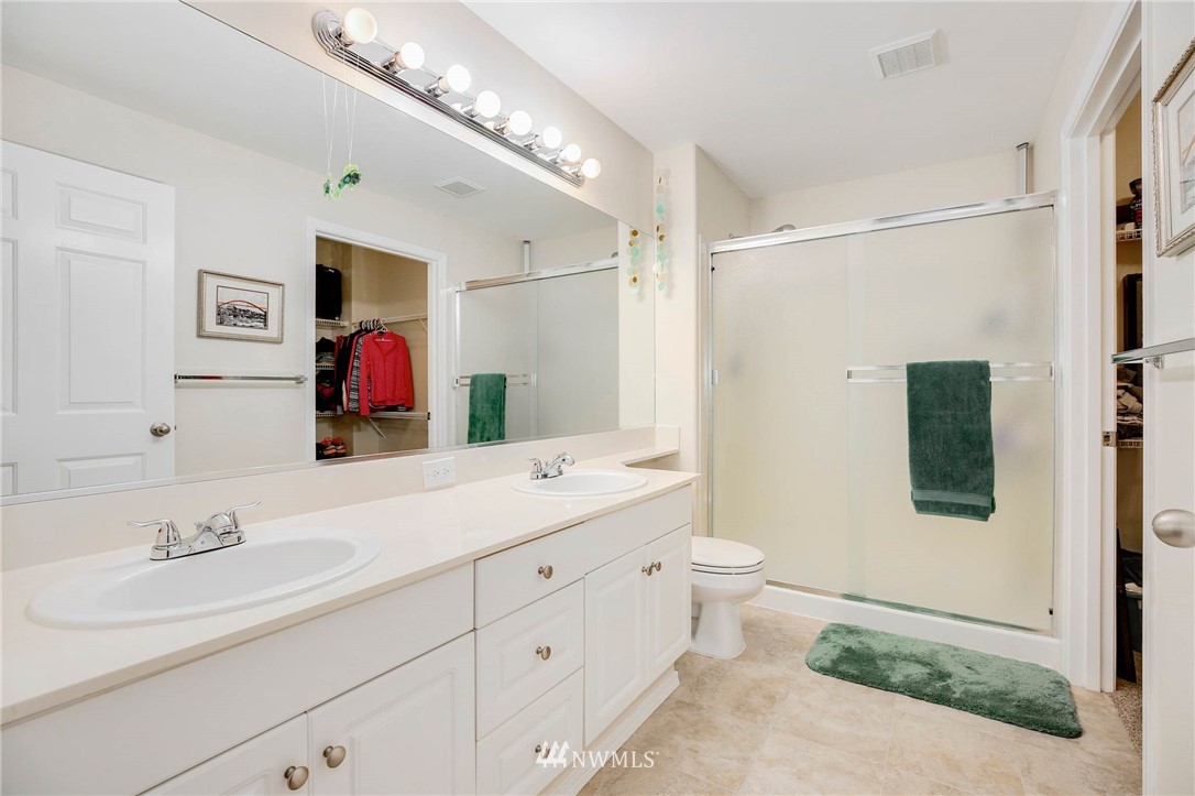 4522 Northeast 6th Court Renton, WA 98059 - Photo 14 of 20 a bathroom with a double vanity sink mirror and toilet