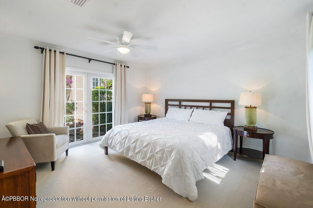 257 Fairview Road Palm Beach, FL 33480 - Photo 13 of 20 a bedroom with a large bed and a couch