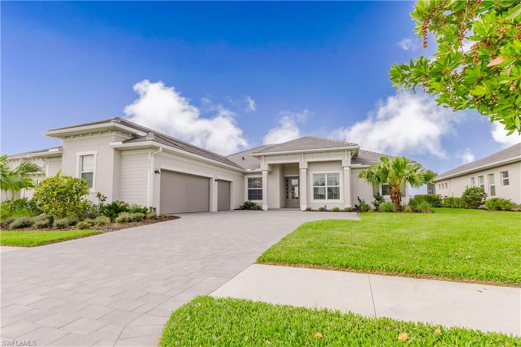 5439 Ternberry Road Ave Maria, FL 34142 - Photo 1 of 50 a front view of a house with a garden and yard