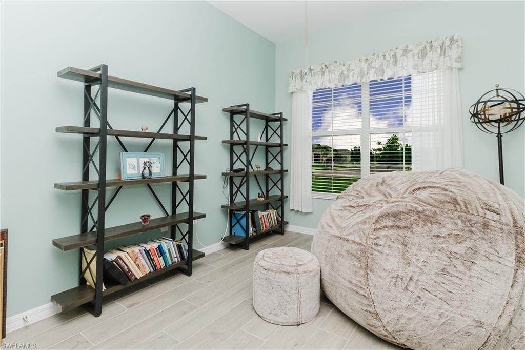 5439 Ternberry Road Ave Maria, FL 34142 - Photo 12 of 50 a bedroom with furniture and a large window