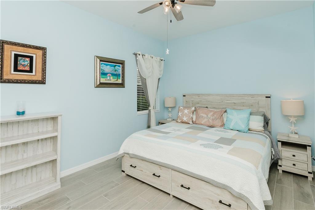 5439 Ternberry Road Ave Maria, FL 34142 - Photo 18 of 50 a bedroom with a bed and a chandelier