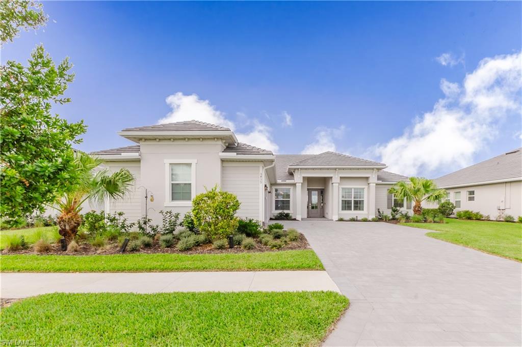 5439 Ternberry Road Ave Maria, FL 34142 - Photo 2 of 50 a front view of a house with a garden and yard