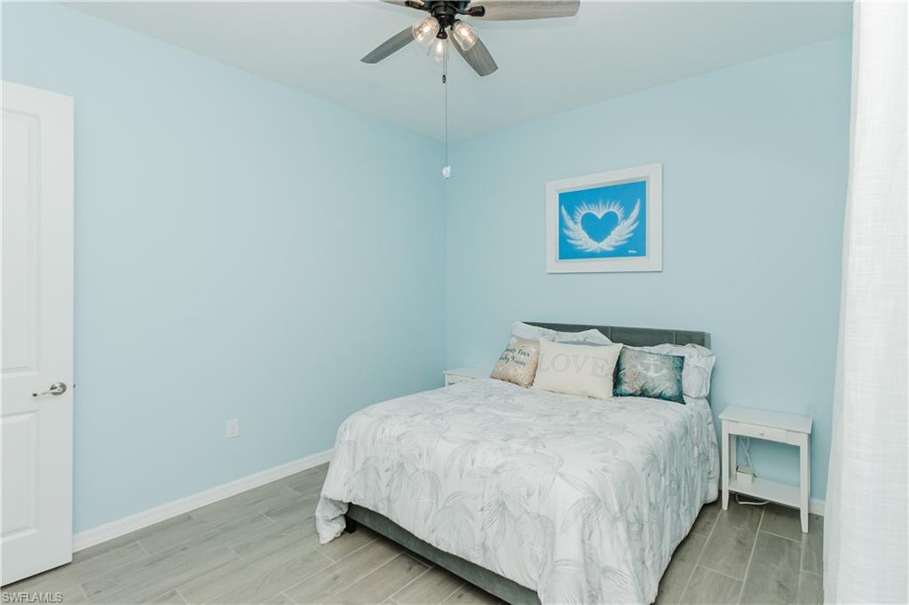 5439 Ternberry Road Ave Maria, FL 34142 - Photo 21 of 50 a bedroom with a bed and a chandelier
