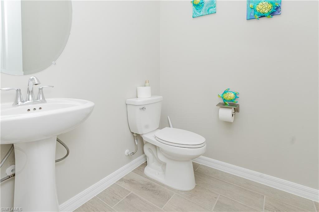 5439 Ternberry Road Ave Maria, FL 34142 - Photo 23 of 50 a white toilet sitting next to a bathroom sink