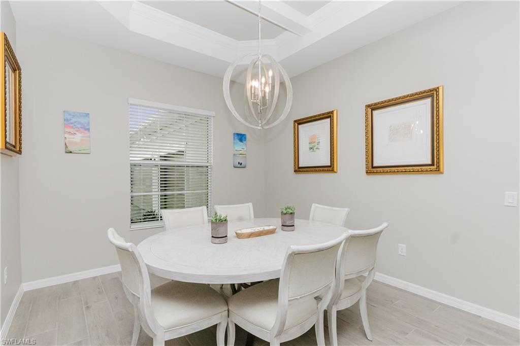 5439 Ternberry Road Ave Maria, FL 34142 - Photo 10 of 50 a view of a dining room with furniture and chandelier