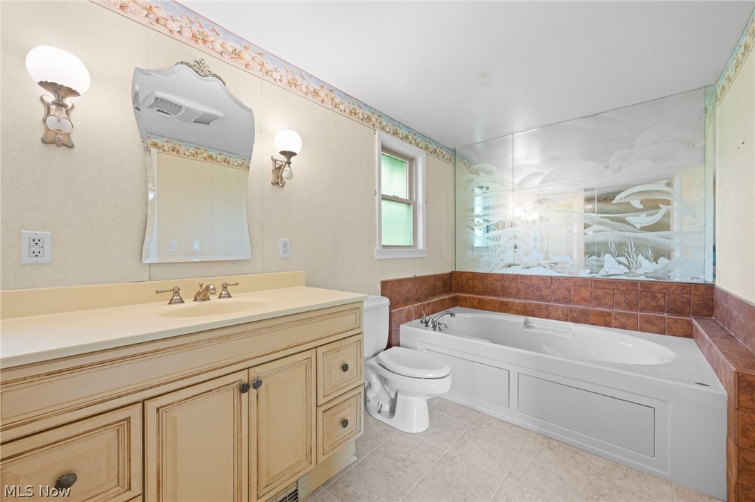 8106 Middlesex Road Mentor, OH 44060 - Photo 16 of 32 Bathroom with a tub, tile flooring, and large vanity