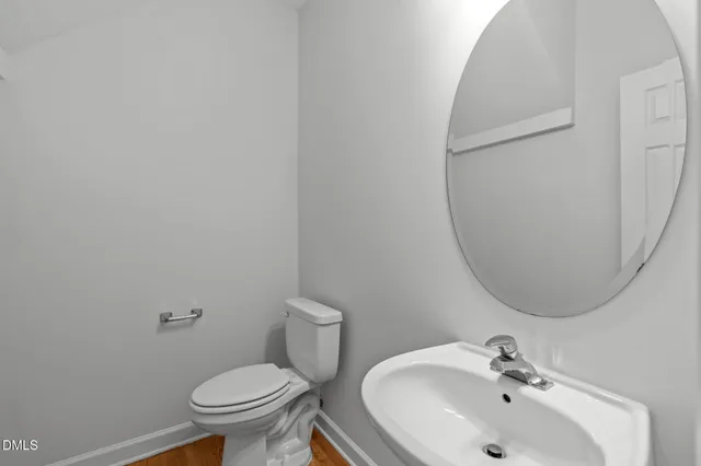 a white toilet sitting next to a bathroom sink