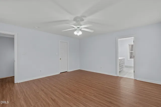 a view of an empty room with wooden floor