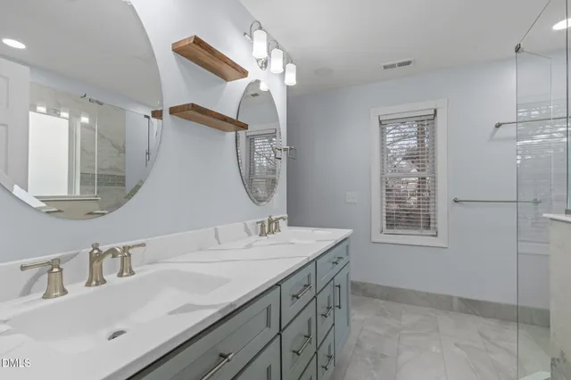 a bathroom with a double vanity sink mirror and double