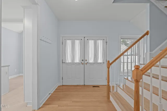 a view of an entryway with wooden floor