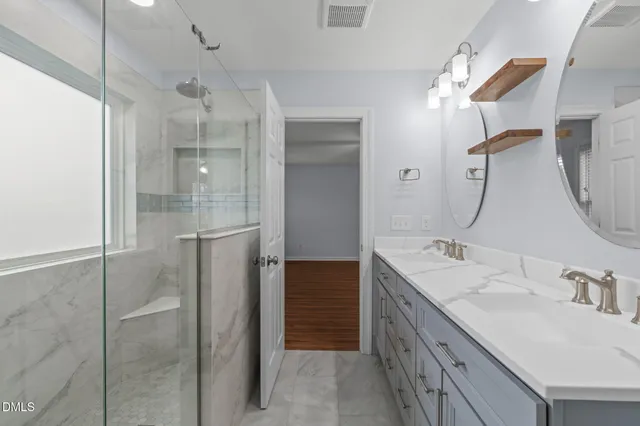a bathroom with a double vanity sink mirror and double