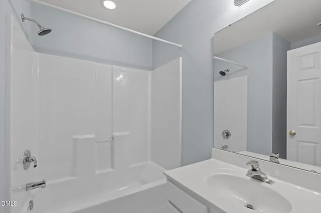 a bathroom with a bathtub and a sink