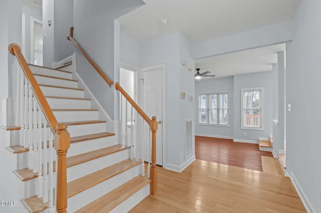 a view of entryway and hall with wooden floor