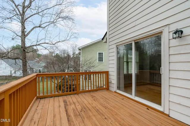 a view of a wooden deck with a yard