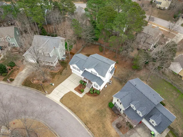an aerial view of a house with a yard