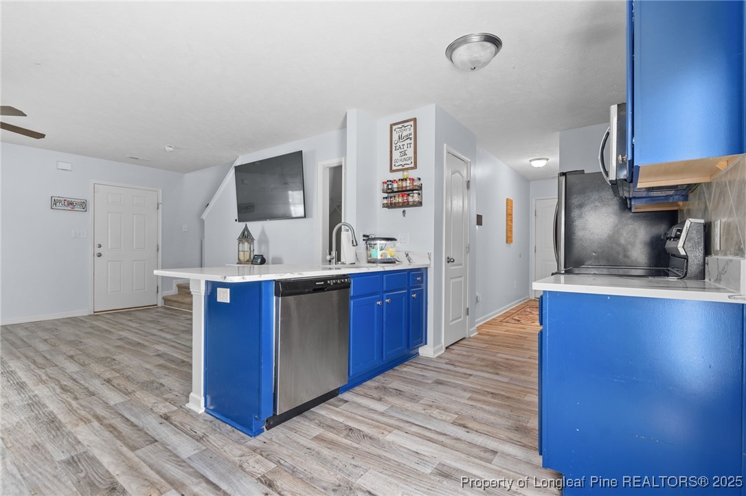 332 Dundee Circle Raeford, NC 28376 - Photo 11 of 35 a kitchen with stainless steel appliances granite countertop a sink stove and refrigerator