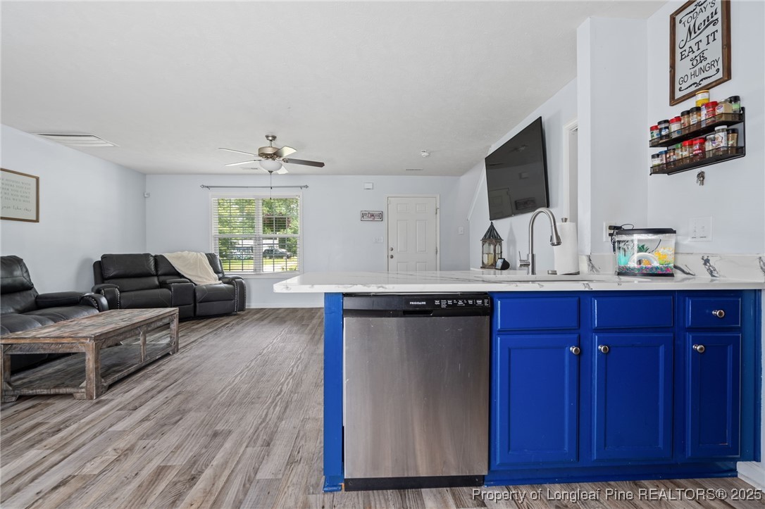 332 Dundee Circle Raeford, NC 28376 - Photo 12 of 35 a living room with furniture a flat screen tv and kitchen view