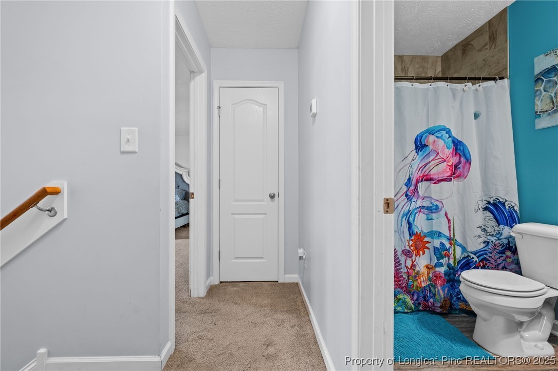 332 Dundee Circle Raeford, NC 28376 - Photo 17 of 35 a view of bathroom with a toilet and a shower curtain