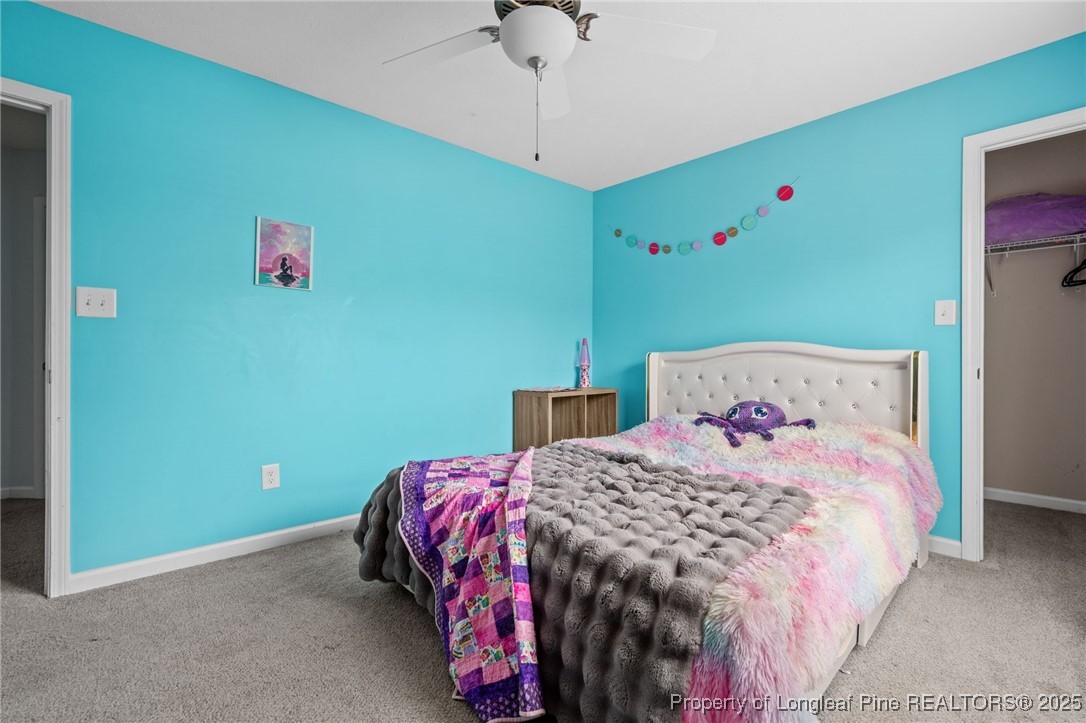 332 Dundee Circle Raeford, NC 28376 - Photo 19 of 35 a bedroom with a bed and a chandelier