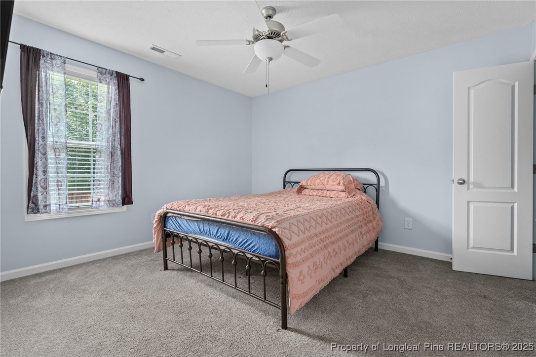 332 Dundee Circle Raeford, NC 28376 - Photo 21 of 35 a bed sitting in a room next to a window