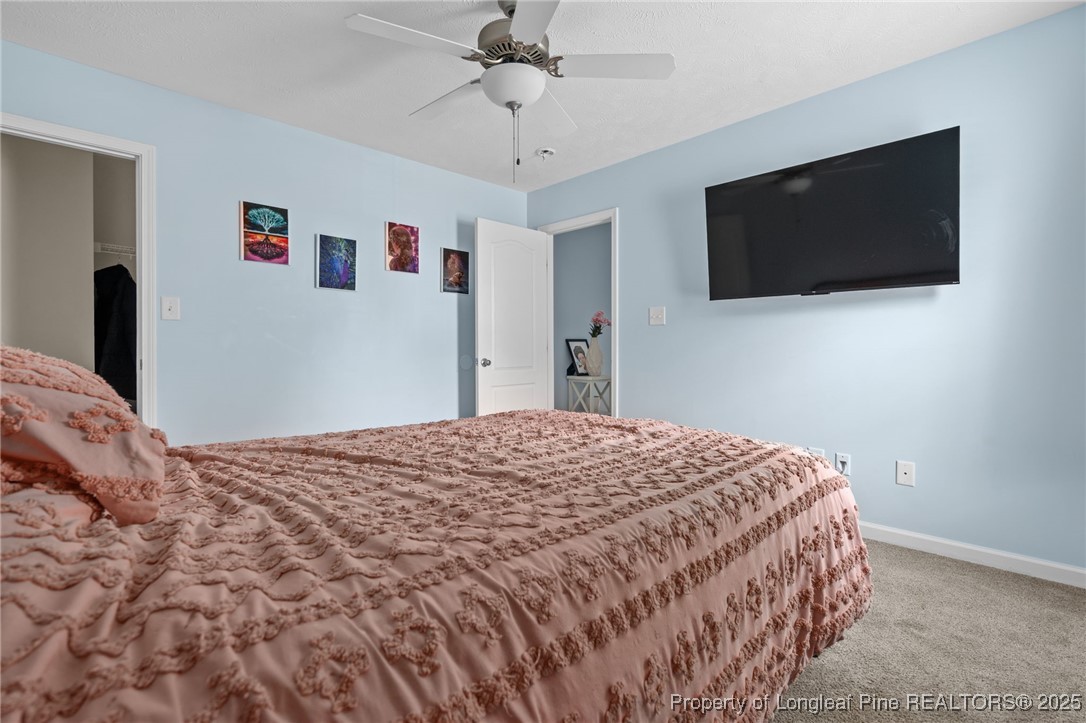 332 Dundee Circle Raeford, NC 28376 - Photo 22 of 35 a bedroom with a bed and a flat screen tv
