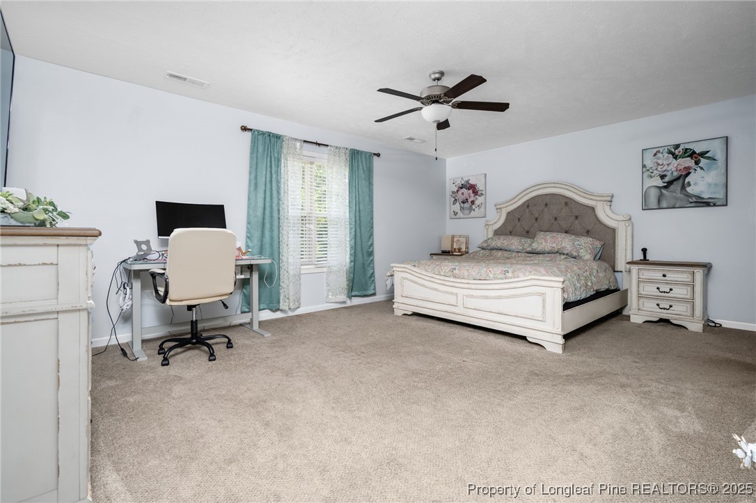 332 Dundee Circle Raeford, NC 28376 - Photo 25 of 35 a bedroom with a bed and a chandelier