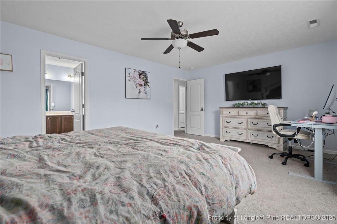 332 Dundee Circle Raeford, NC 28376 - Photo 26 of 35 a bedroom with a bed and a flat screen tv