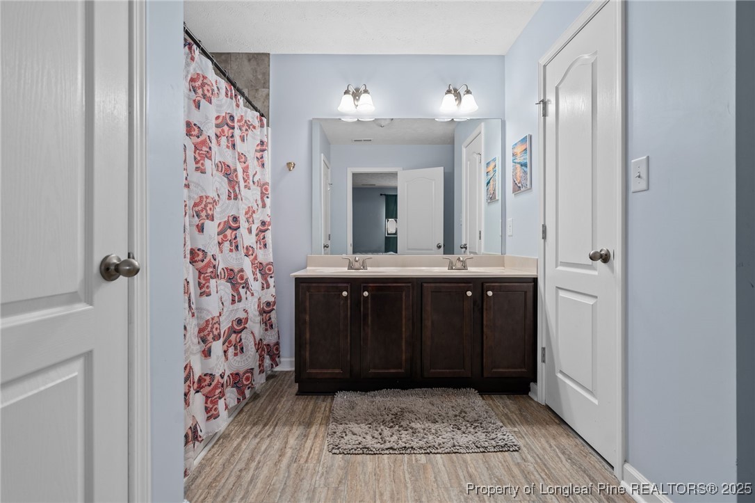 332 Dundee Circle Raeford, NC 28376 - Photo 27 of 35 a bathroom with a sink and a mirror