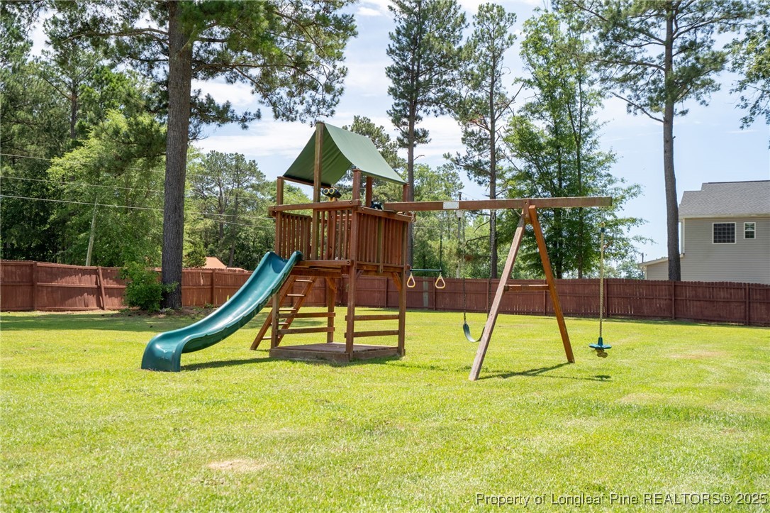 332 Dundee Circle Raeford, NC 28376 - Photo 33 of 35 a view of wooden deck with a slide