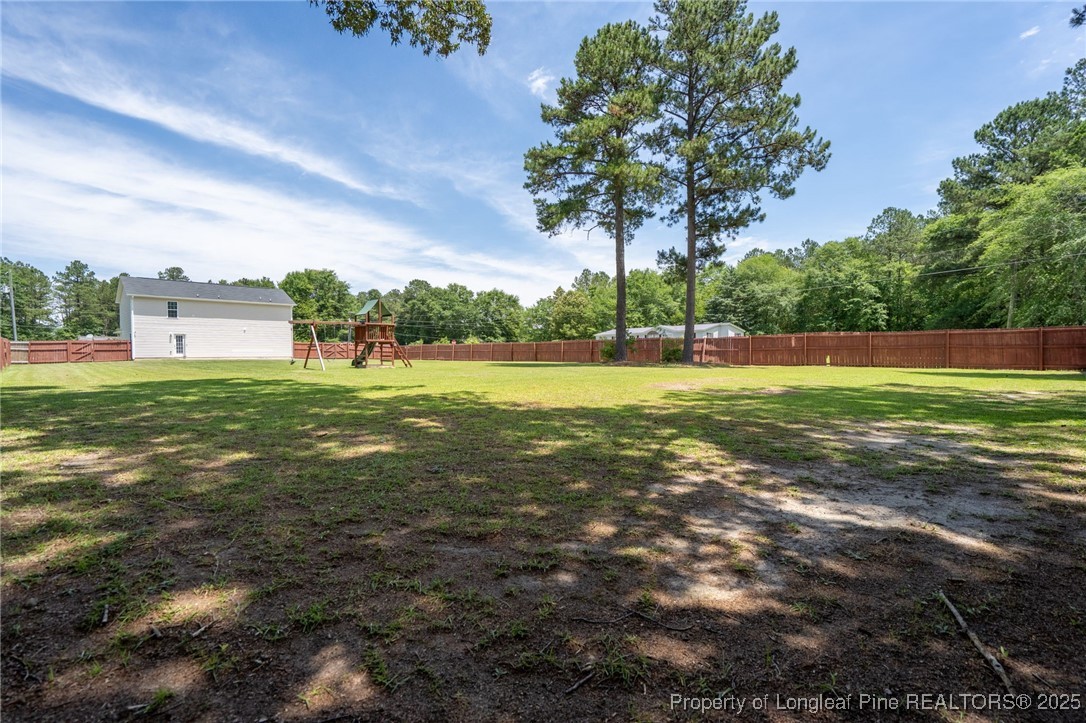 332 Dundee Circle Raeford, NC 28376 - Photo 35 of 35 a view of a big yard with a fountain and large trees