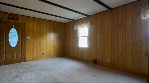 a kitchen with cabinets wooden floor and stainless steel appliances