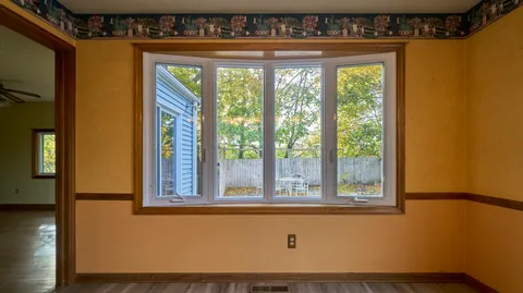 a view of a room with wooden floor and door