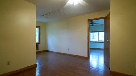 a bathroom with a granite countertop toilet sink and mirror