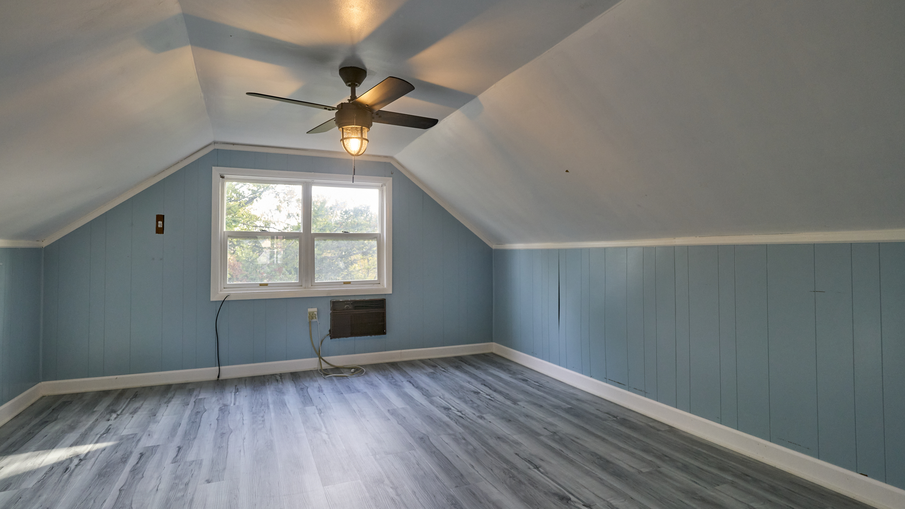 123 Beverly Drive Bridgeport, CT 06610 - Photo 25 of 34 an empty room with wooden floor chandelier fan and windows