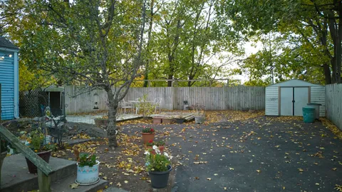 a backyard of a house with table and chairs