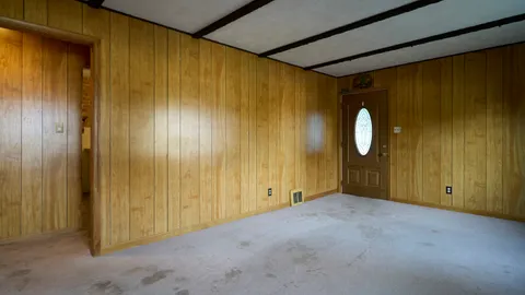 an empty room with windows and closet
