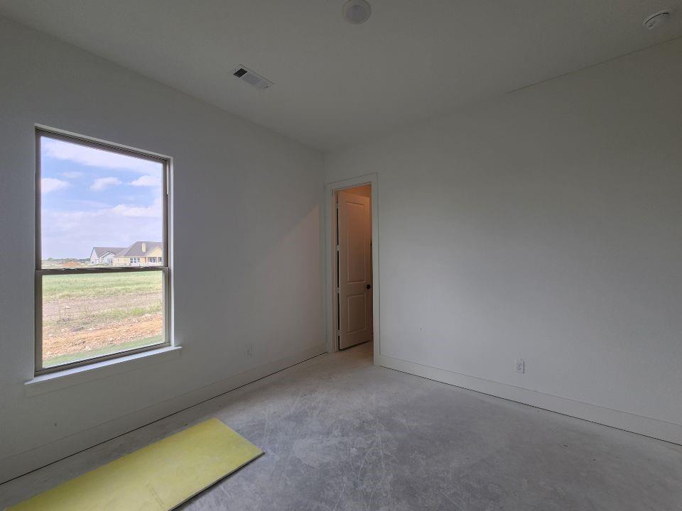 2408 Quartz Street Krum, TX 76249 - Photo 12 of 16 a view of an empty room with a window