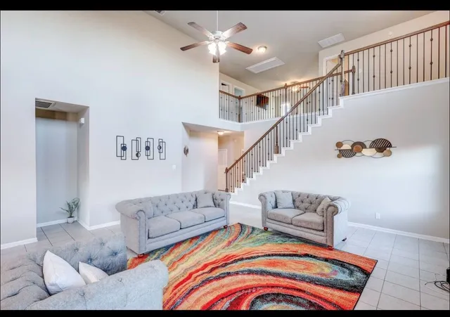 a living room with furniture and stairs