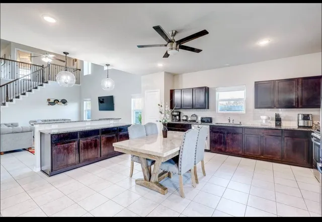 a large kitchen with cabinets wooden floor and stainless steel appliances