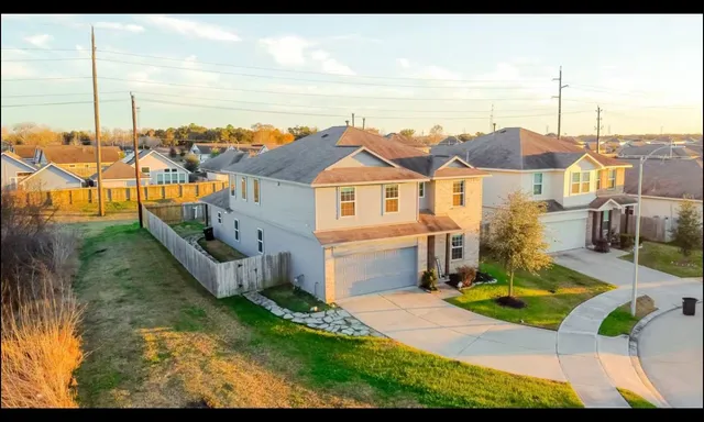 a view of a house with a yard and lake view