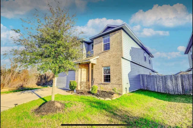 a view of a house with backyard and sitting area