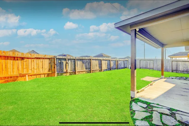 a view of yard with swimming pool and seating area