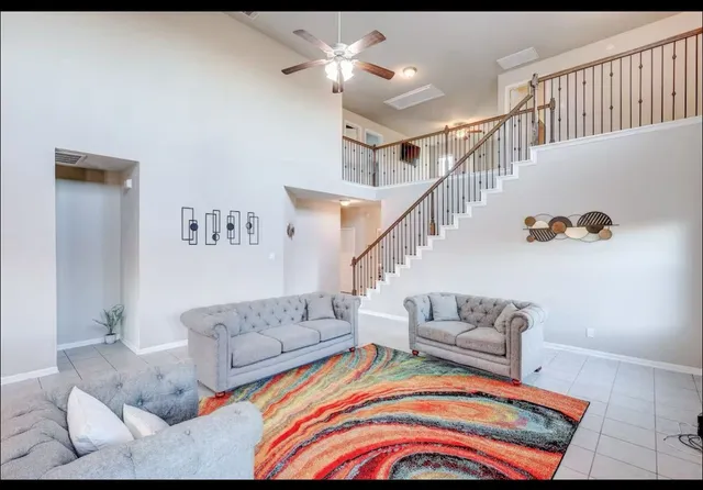 a living room with furniture and stairs