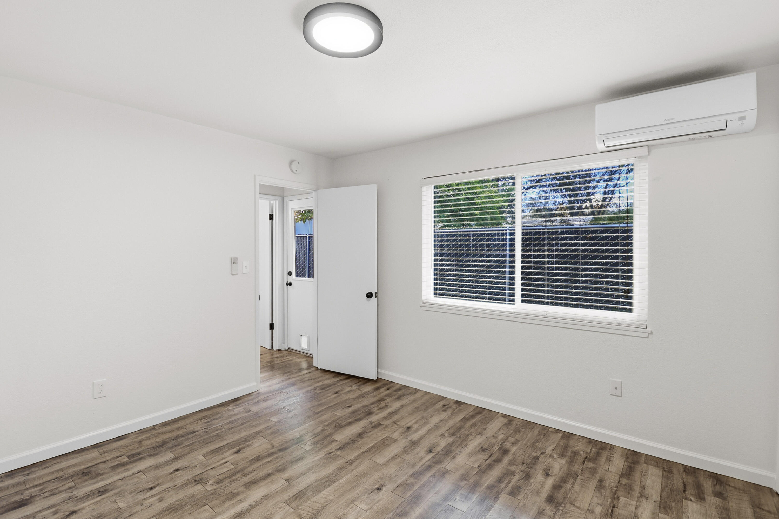 2358 Balls Ferry Road Anderson, CA 96007 - Photo 14 of 24 a view of an empty room with wooden floor and a window