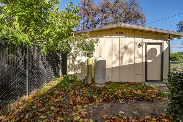 a front view of house with yard barbeque and outdoor seating