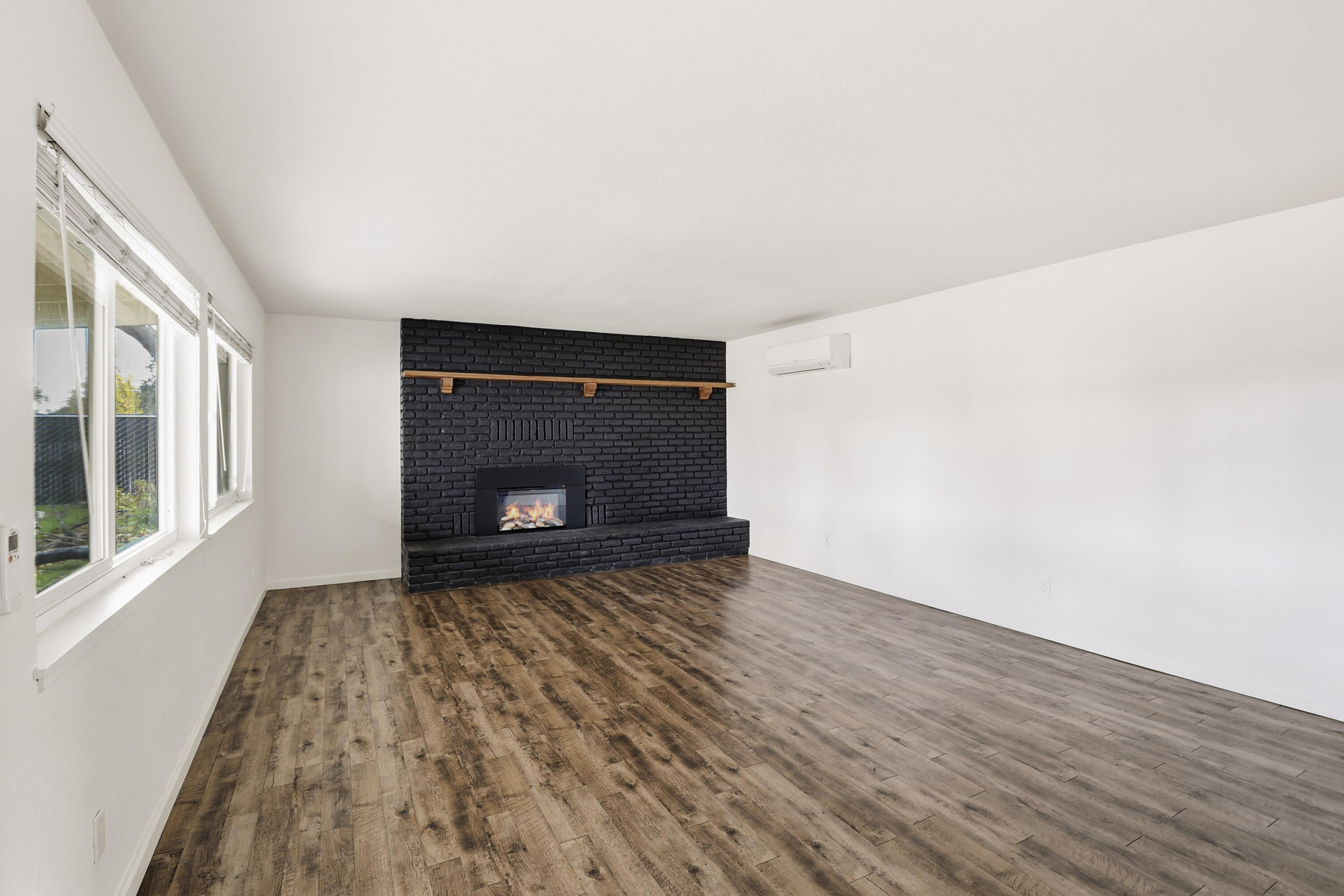 2358 Balls Ferry Road Anderson, CA 96007 - Photo 3 of 24 a view of empty room with wooden floor and fireplace
