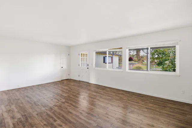 a kitchen with granite countertop a stove cabinets and a wooden floor