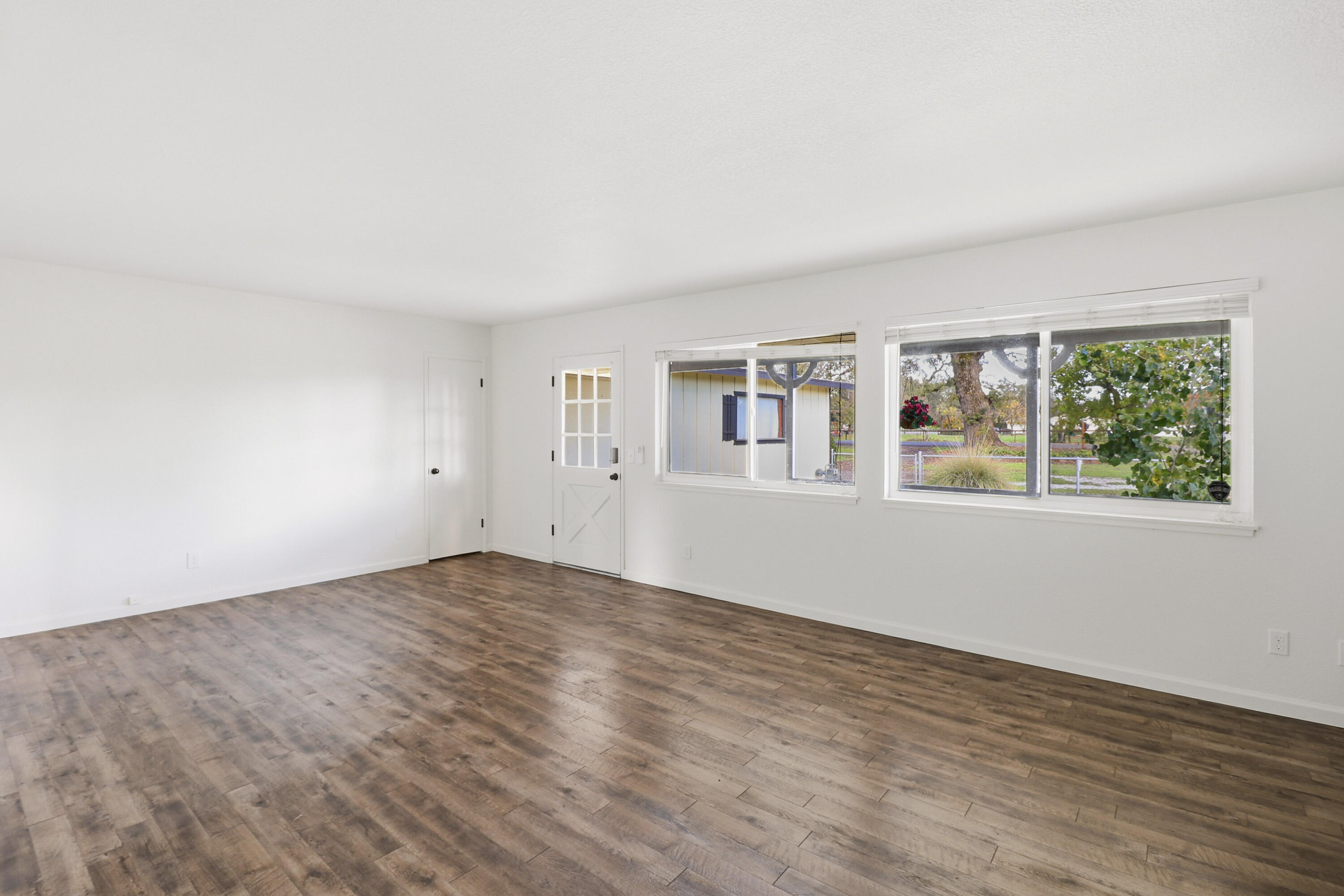 2358 Balls Ferry Road Anderson, CA 96007 - Photo 4 of 24 an empty room with wooden floor and windows