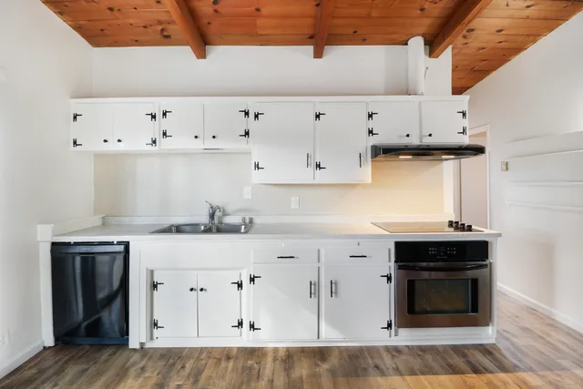 a view of a room with wooden floor
