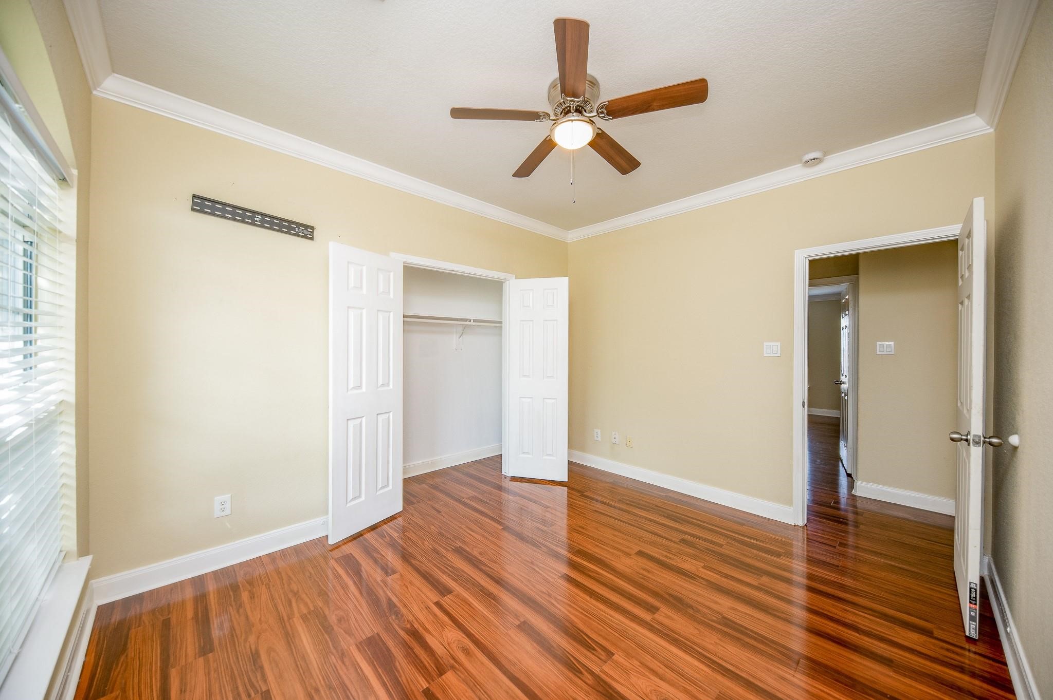4409 Juan Carlos Court Rosenberg, TX 77471 - Photo 19 of 32 wooden floor in an empty room with a window